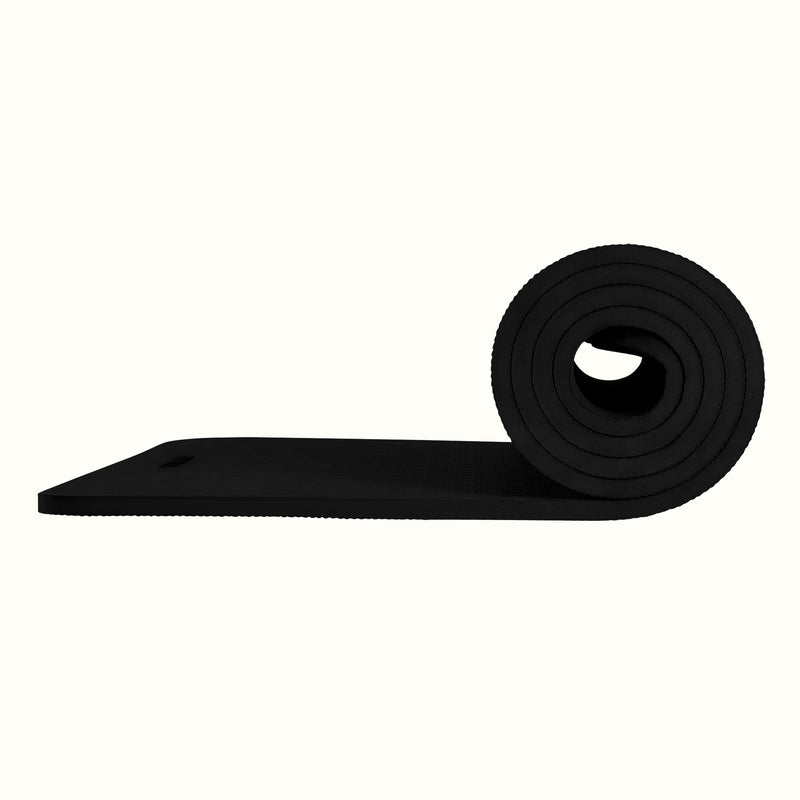 Black Zuma Yoga Mat partially rolled on a white background, showing texture and thickness.