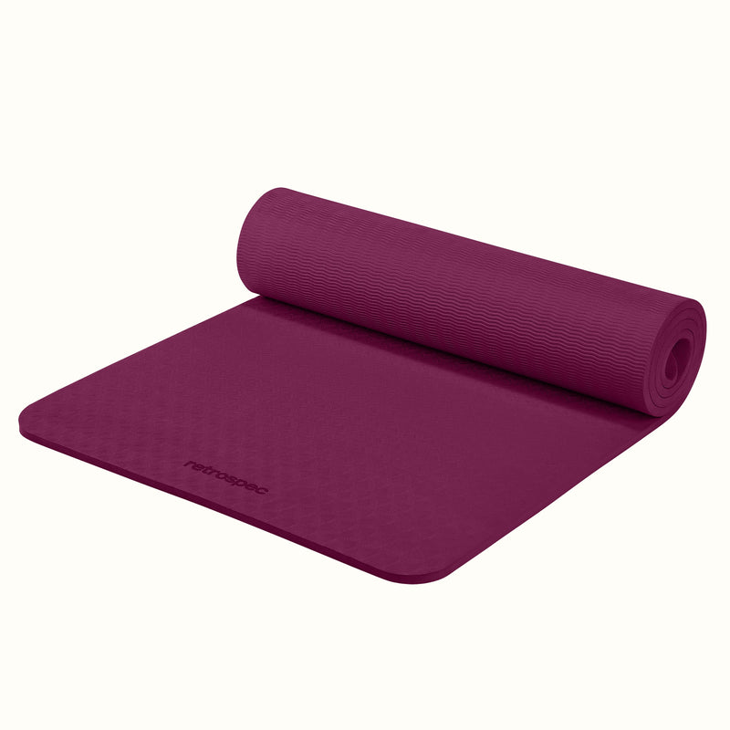 Partially rolled out Boysenberry Zuma Yoga Mat with textured surface on a white background.