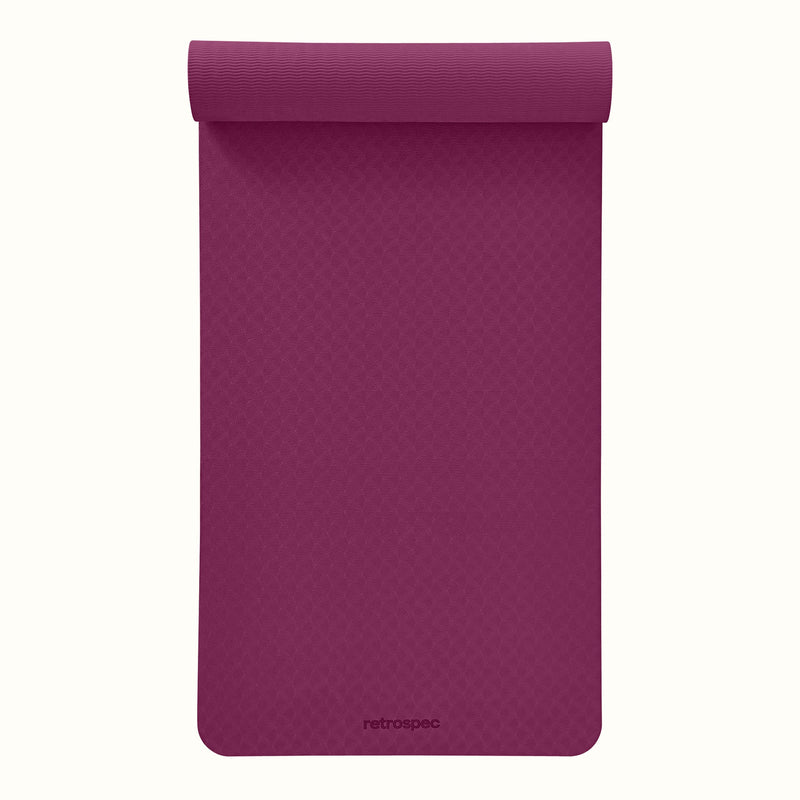 Partially rolled out Boysenberry Zuma Yoga Mat with textured surface on a white background.