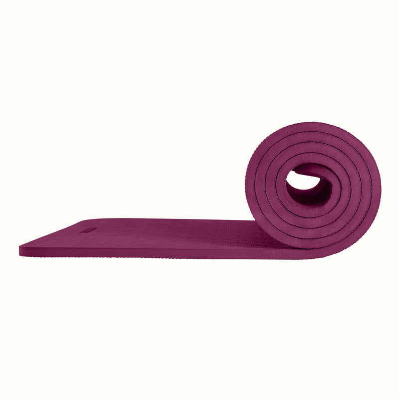 Boysenberry Zuma Yoga Mat partially rolled on a white background, showing texture and thickness.