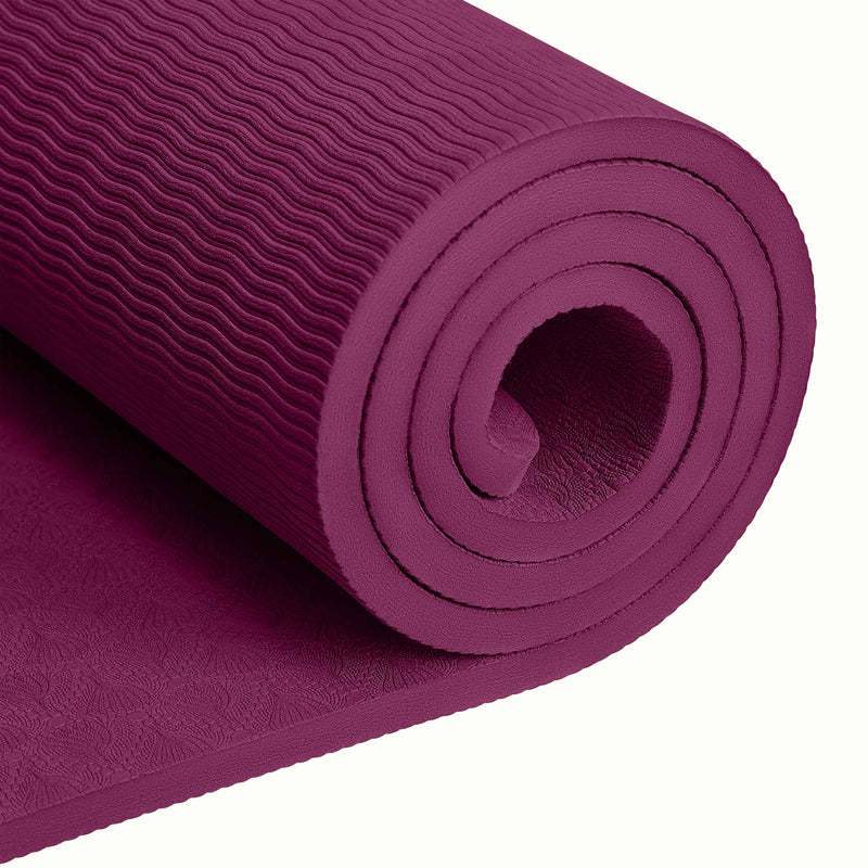 Close-up of a tightly rolled Boysenberry textured Zuma Yoga Mat with wavy patterned surface on a white background.