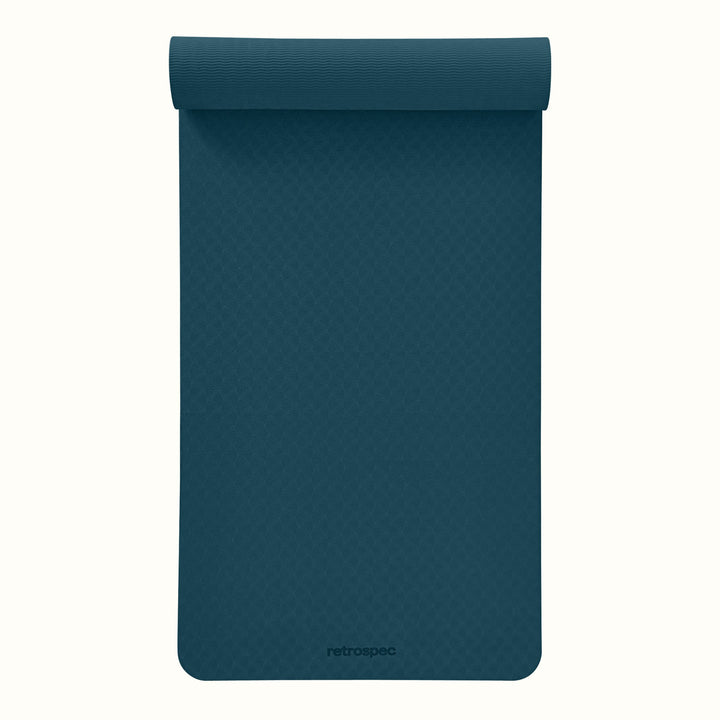 Partially rolled out Ocean Blue Zuma Yoga Mat with textured surface on a white background.