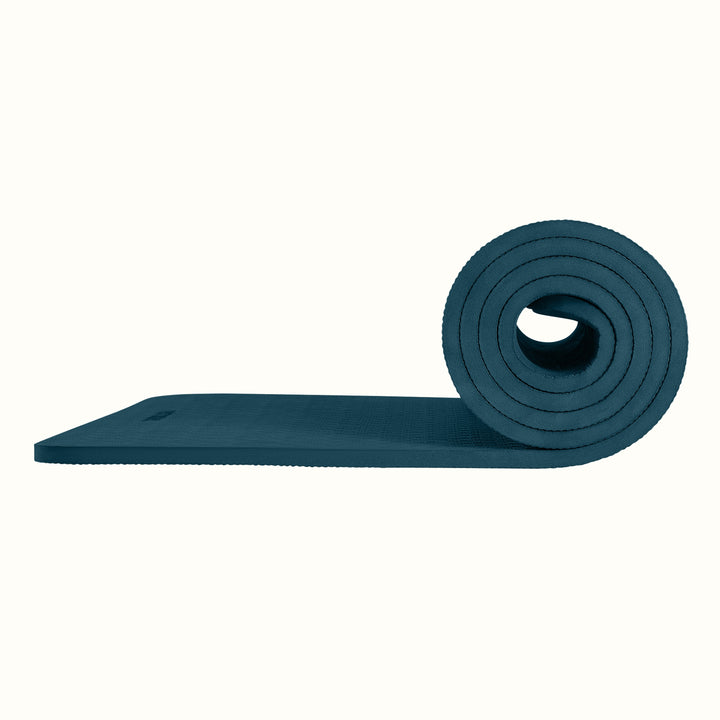 Ocean Blue Zuma Yoga Mat partially rolled on a white background, showing texture and thickness.