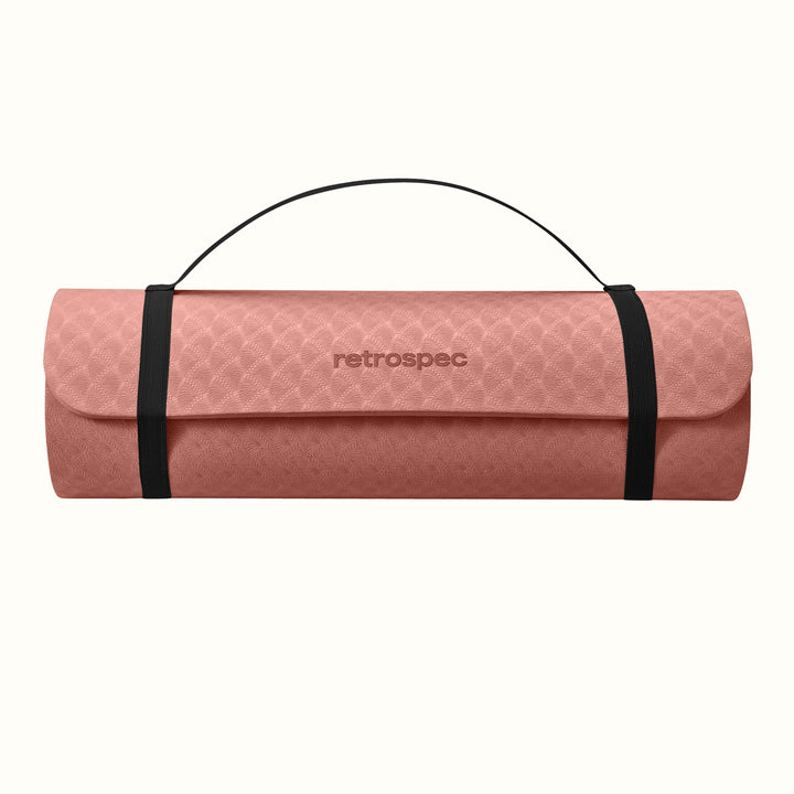 Rose rolled-up yoga mat with carrying strap and "retrospec" logo on a white background.
