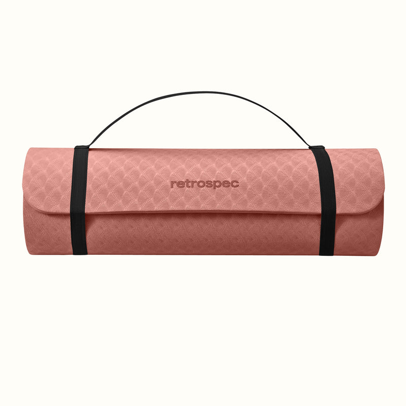 Rose rolled-up yoga mat with carrying strap and "retrospec" logo on a white background.