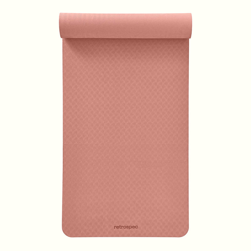 Partially rolled out Rose Zuma Yoga Mat with textured surface on a white background.