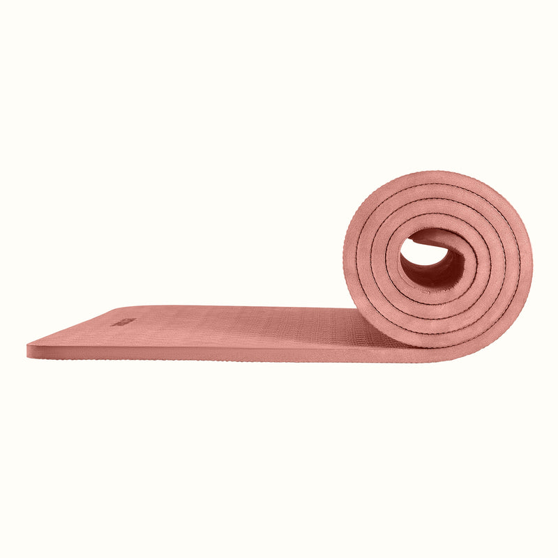 Rose Zuma Yoga Mat partially rolled on a white background, showing texture and thickness.