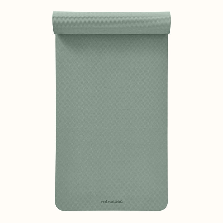 Partially rolled out Sage Zuma Yoga Mat with textured surface on a white background.