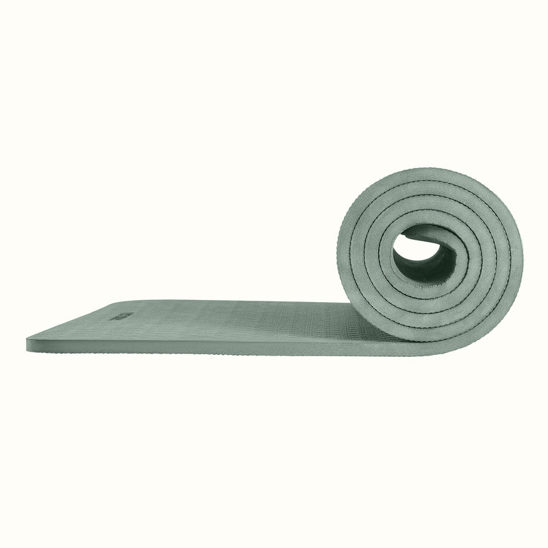 Sage Zuma Yoga Mat partially rolled on a white background, showing texture and thickness.