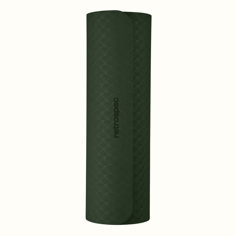 Rolled up Wild Spruce Zuma Yoga Mat with textured surface on a white background.