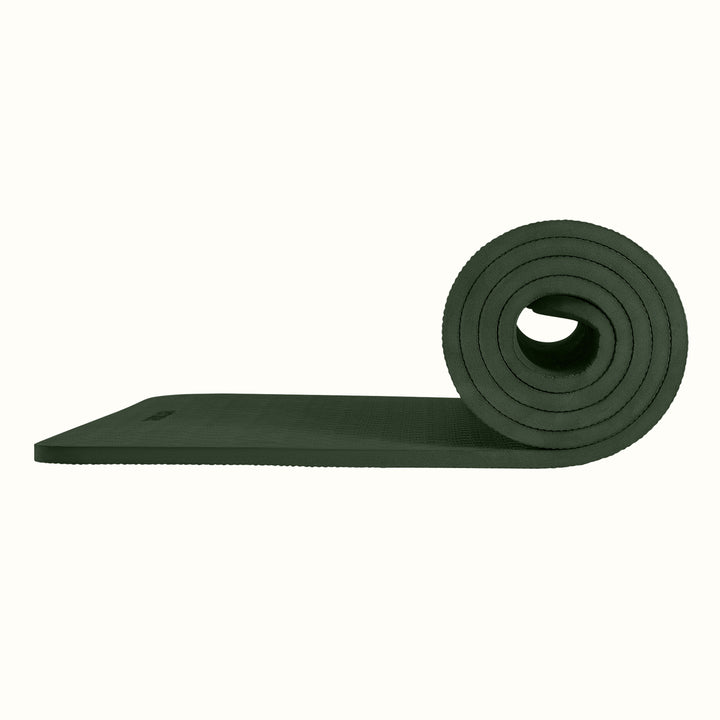 Wild Spruce Zuma Yoga Mat partially rolled on a white background, showing texture and thickness.