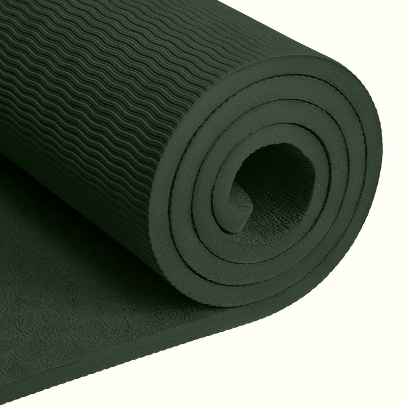Close-up of a tightly rolled Wild Spruce textured Zuma Yoga Mat with wavy patterned surface on a white background.